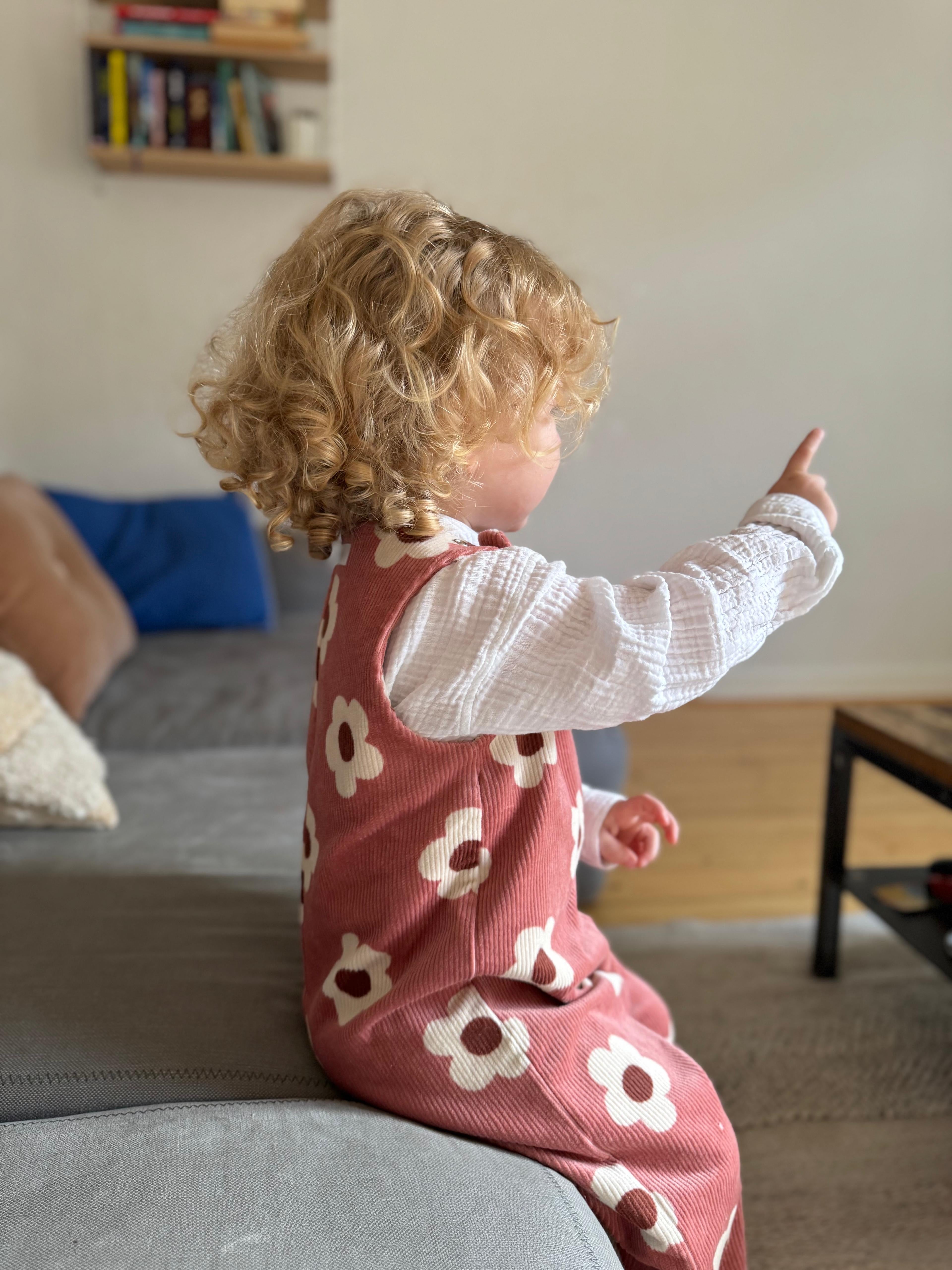 Baby Overall und Strampler mit rosa Blumen am Model,Seitenansicht